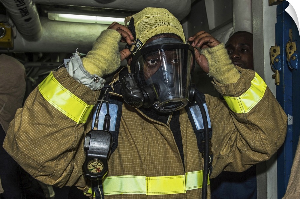 East China Sea, February 6, 2015 - Seaman dons his firefighting ensemble during a general quarters drill aboard the amphib...