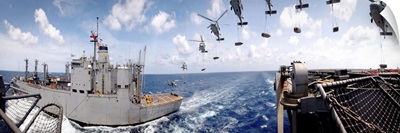SH60 helicopters transfer ammunition between USS Harry S Truman and USNS Mount Baker