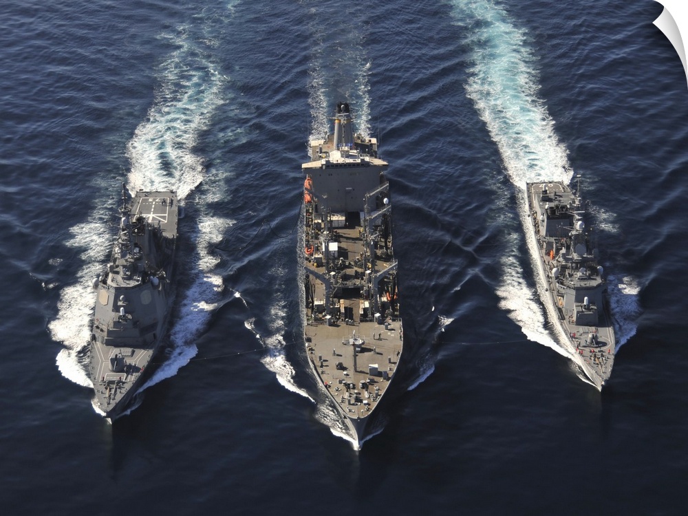 December 5, 2010 - The Military Sealift Command fleet replenishment oiler USNS Tippecanoe (T-AO 199), center, refuels the ...