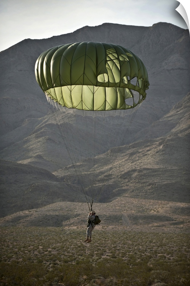 April 15, 2011 - Soldier prepares to land after a static-line jump from a CH-47 Chinook helicopter, as part of airdrop and...