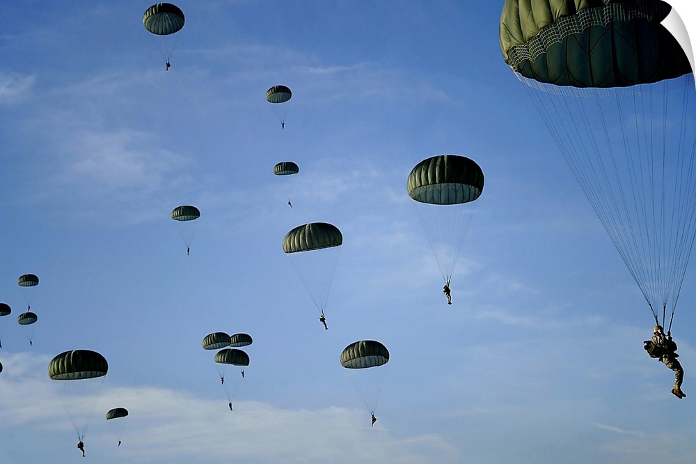Soldiers descend under a parachute canopy during Operation Toy Drop.
