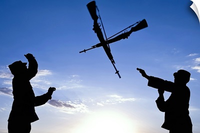 Soldiers practice an over-the-head rifle toss