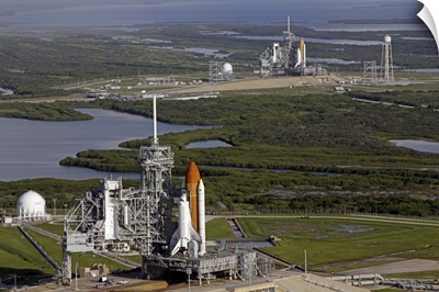 Space Shuttle Atlantis and Endeavour sit on their launch pads at Kennedy Space Center