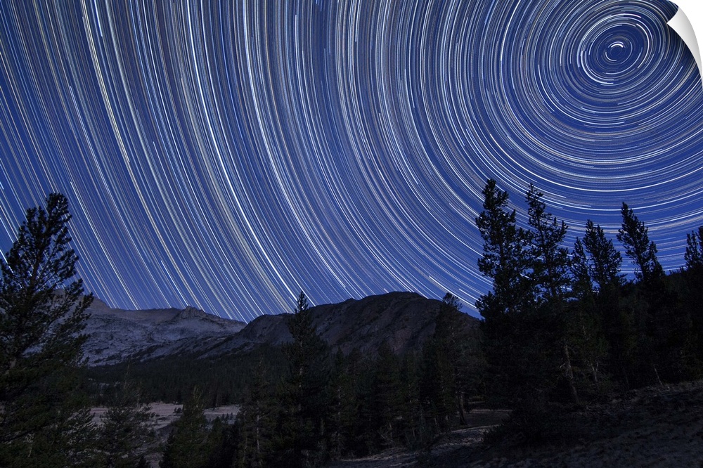 Star trails above mountain peaks in the high sierras near Yosemite National Park, California.