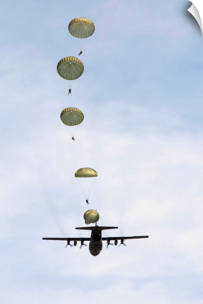 Students jump from a C-130 Hercules.