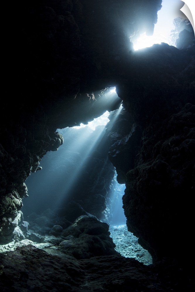 Sunlight descends underwater and into a crevice in a reef in the Solomon Islands.