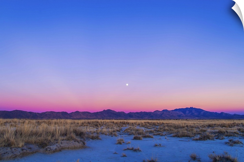 December 15, 2013 - Sunset twilight colors and the waxing gibbous moon over the Chiricahua Mountains in southeast Arizona,...
