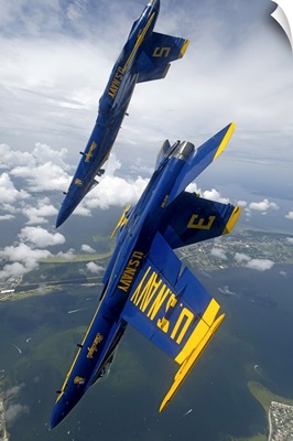 The Blue Angels perform a looping maneuver over Pensacola Beach, Florida