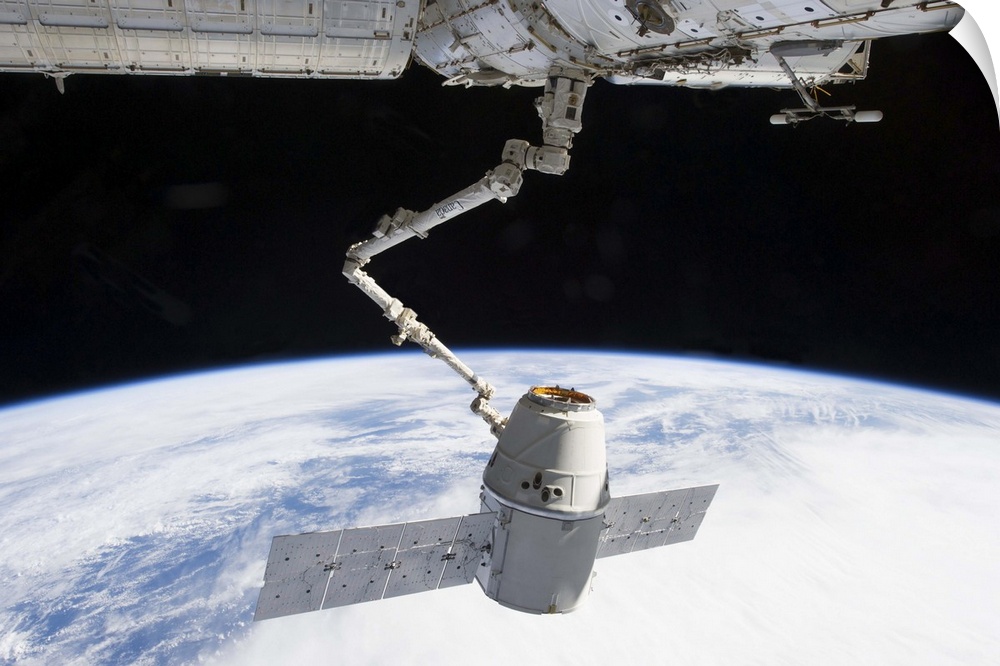 March 3, 2013 - The docking of SpaceX Dragon to the International Space Station above a blue and white Earth.