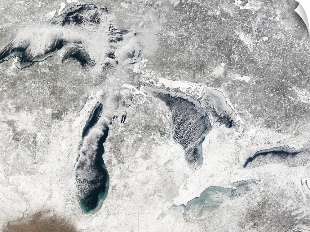 A large aerial view of the great lakes during the winter season and covered in snow.