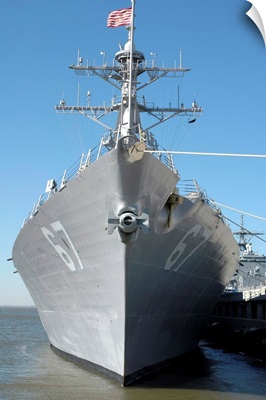 The guided missile destroyer USS Cole sits moored to a pier