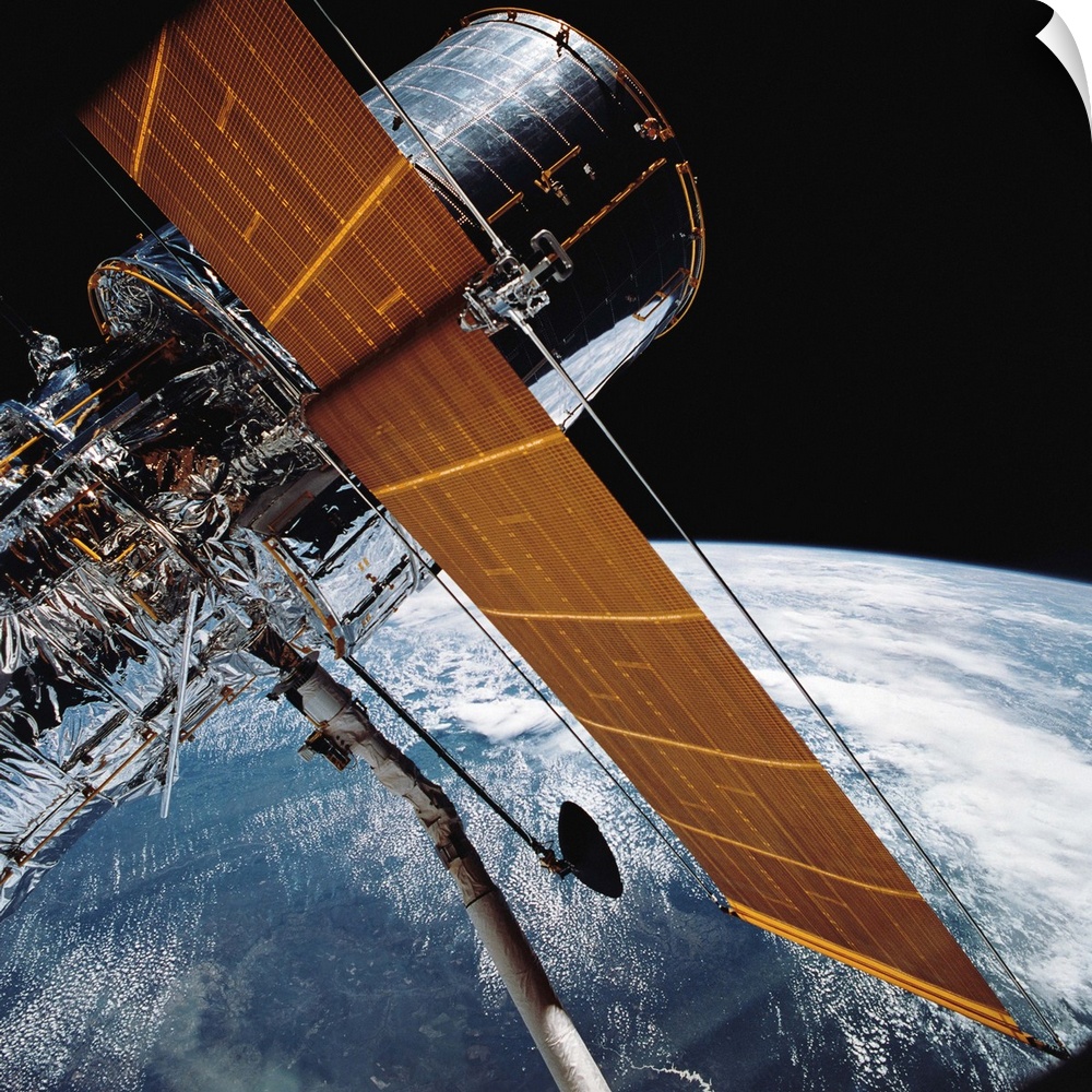 April 25, 1990 - The Hubble Space Telescope backdropped by planet Earth.