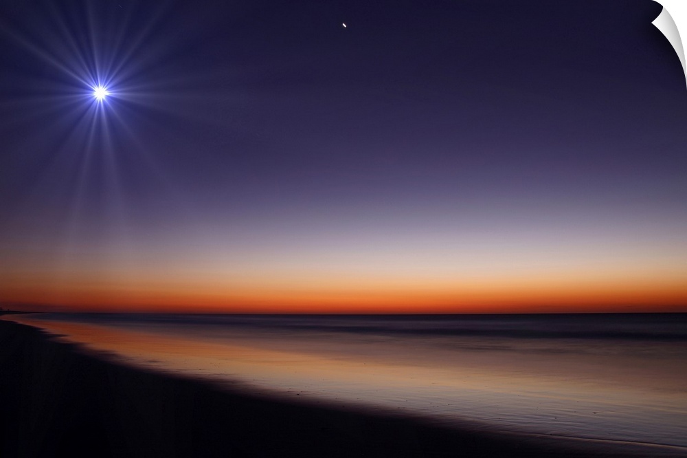 Big photo on canvas of a bright moon and Venus in the dusk sky above an ocean.