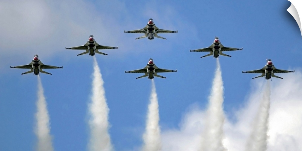 Photograph of six military planes in formation with smoke trails.