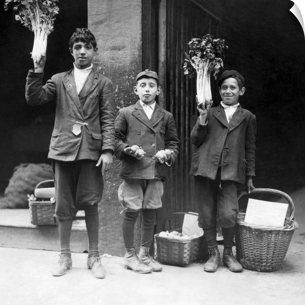 Three boys selling fruits and vegetables on the streets of Boston, Massachusetts in 1909.