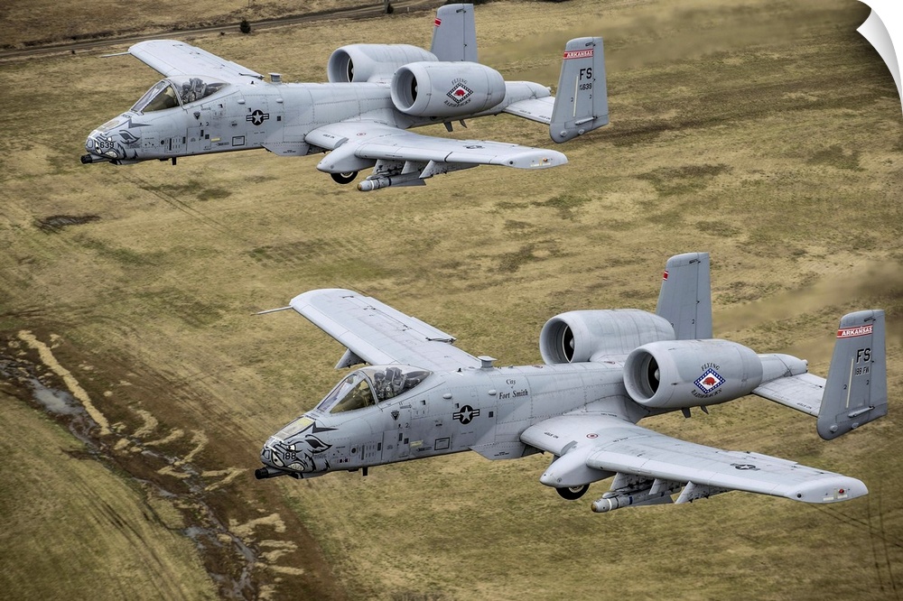 December 30, 2013 - Two A-10 Thunderbolt II's conduct a training mission over Razorback Range at Fort Chaffee Maneuver Tra...