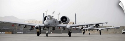 Two A10 Thunderbolts taxi out to the runway