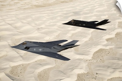 Two F-117 Nighthawk stealth fighters fly over White Sands National Monument