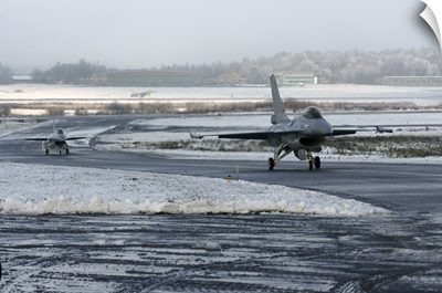 Two F-16 Fighting Falcons taxi down the runway in Florennes, Belgium