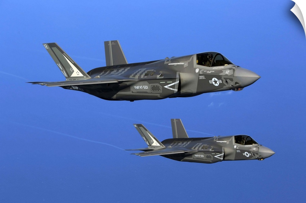 Two F-35B joint strike fighter jets conduct aerial maneuvers.