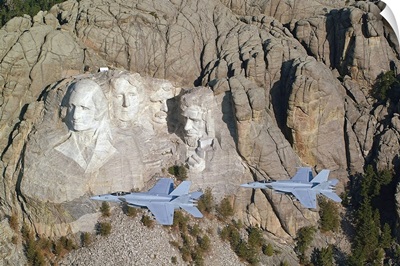 Two F/A18E Super Hornets conduct a fly by of Mount Rushmore