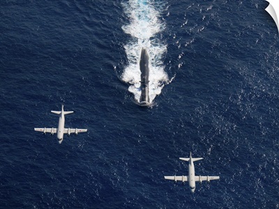 Two P 3 Orion maritime surveillance aircraft fly over attack submarine USS Houston