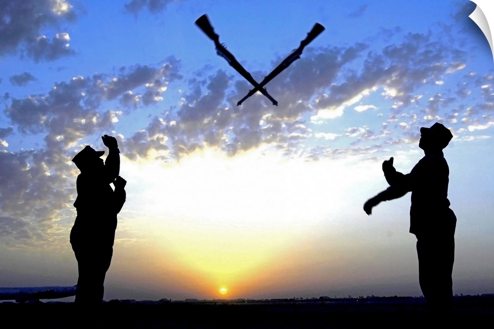 Photograph of two silhouetted soldiers tossing rifles with sunset in distance under a cloudy sky.