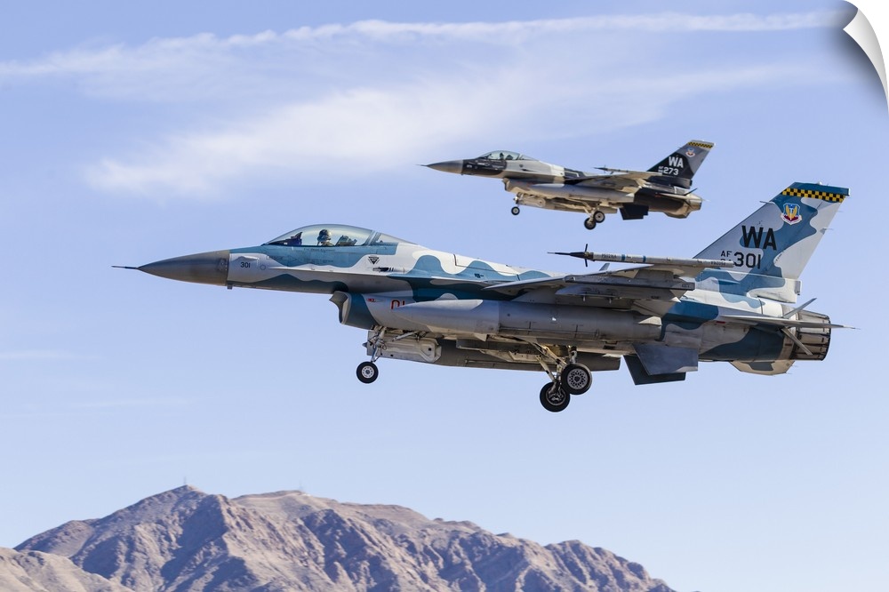 Two U.S. Air Force F-16 Fighting Falcon aggressor aircraft on final approach.