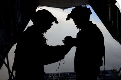 U.S. Air Force loadmasters fold the American flag aboard an HC-130 Hercules