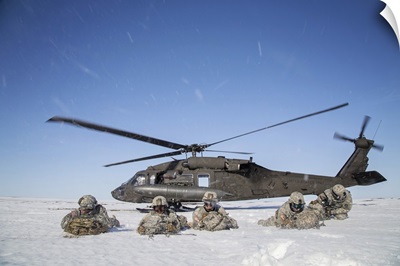 U.S. Army paratroopers pull security after exiting a UH-60 Black Hawk