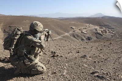 U.S. Army soldier provides security for infantry patrolling through Dandarh village
