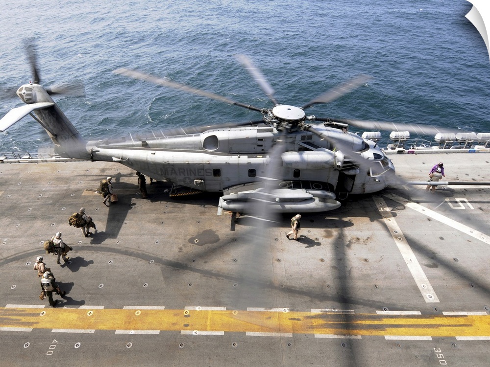 August 12, 2010 - U.S. Marines board an MH-53E Sea Dragon helicopter aboard the USS Peleliu while underway in the North Ar...
