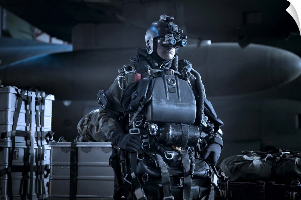 U.S. Navy Seal combat diver equipped with night vision, prepares for HALO jump operations from a C-130 Hercules.
