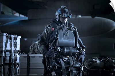 U.S. Navy Seal equipped with night vision prepares for HALO jump operations