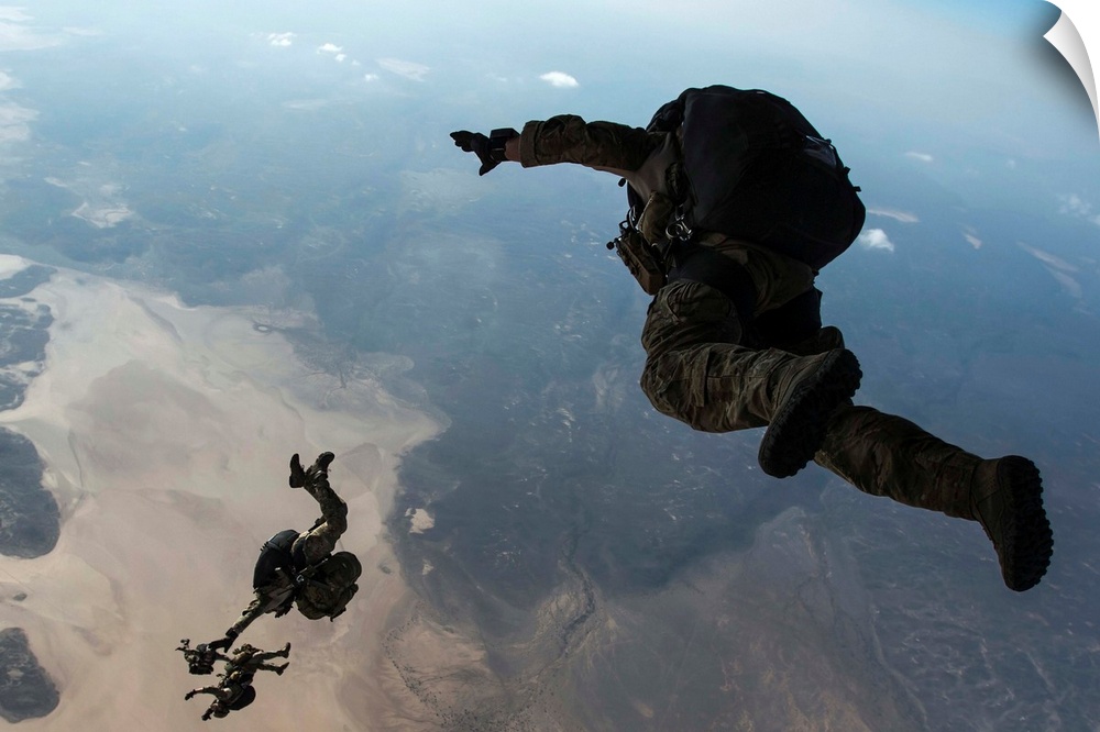 U.S. Pararescuemen and U.S. Marines jump from a HC-130 over Djibouti.