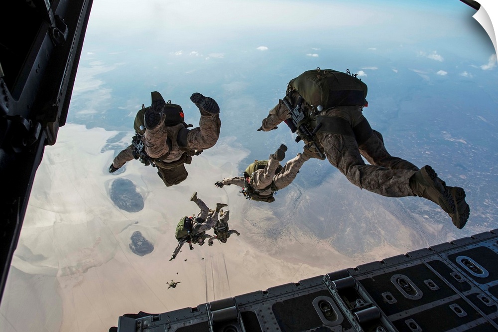 U.S. Pararescuemen and U.S. Marines jump from a HC-130 over Djibouti.