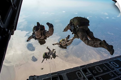 U.S. Pararescuemen and U.S. Marines jump from a HC-130 over Djibouti