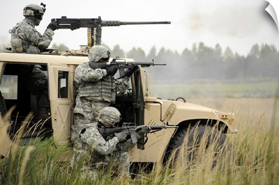 U.S. Soldiers perform a platoon mounted and dismounted live fire exercise