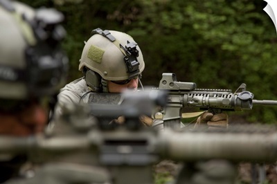 U.S. Special Forces soldiers provide security with automatic rifles