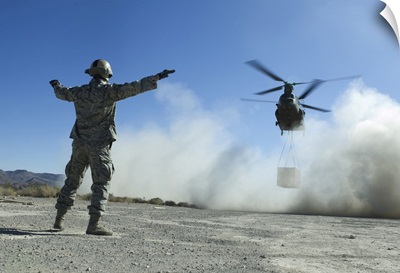 US Air Force Master Sergeant Guides A CH-47 Chinook To A Drop Site