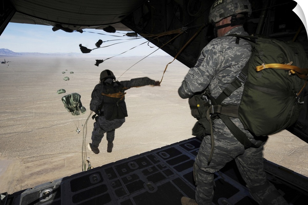 January 26, 2011 - U.S. Airmen jump from a C-130 Hercules aircraft over the Nevada Test and Training Range during Red Flag...