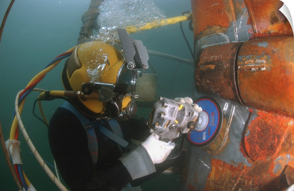 January 4, 2007 - U.S. Navy Diver uses a grinder to file down a repair patch on the submerged bow of the USS Ogden (LPD-5)...