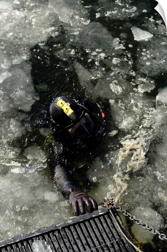 U.S. Navy Diver swims back to the dive training boat after completing a training mission on the Thames River.