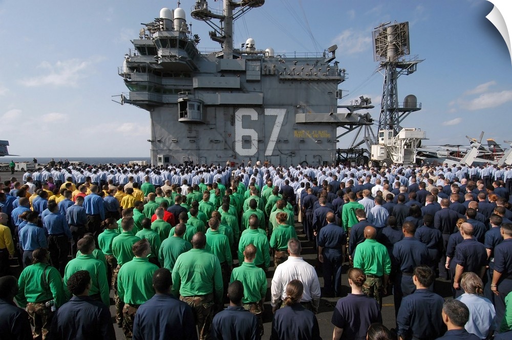 U.S. Navy Sailors stand at attention during a frocking ceremony.