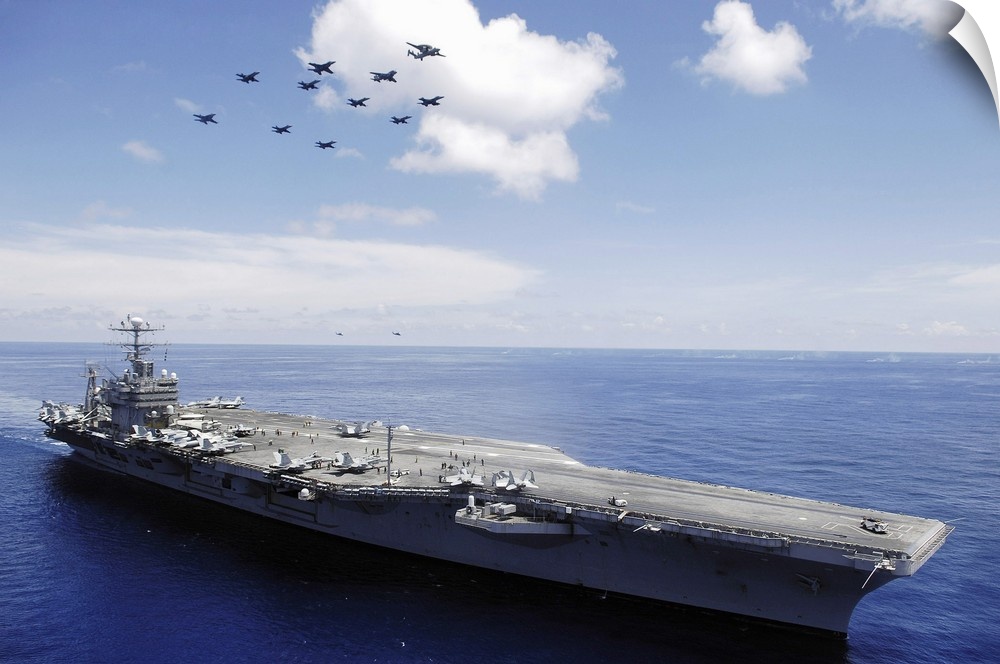 USS Abraham Lincoln and aircraft perform a aerial demonstration.