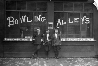 Vintage Photo Of A Row Of Young Boys Posing In Front Of A Bowling Alley Where They Work