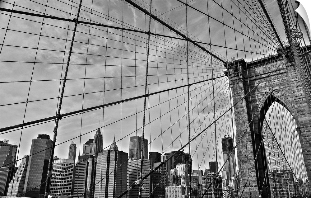 View of the cables from the Brooklyn Bridge with the New York City skyline in the distance.