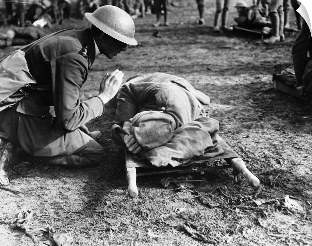 A British priest saying a prayer over a dying German soldier during World War I.