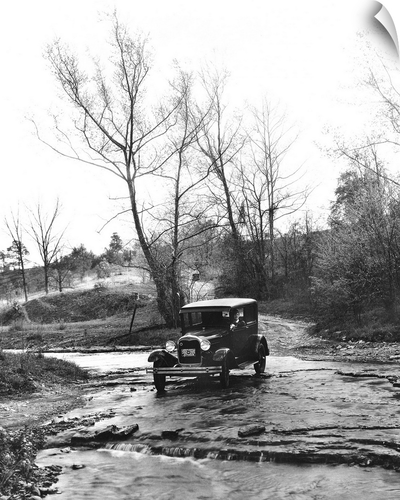 A Model A Ford crossing a creek bed in Oldham County, Kentucky. Photograph, 1930.