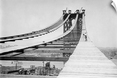 A photographer on the temporary foot path atop the Manhattan Bridge, 1908